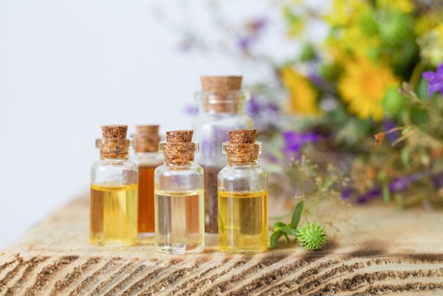 Small bottles with essential oils on wooden table. Alternative medicine concept ätherische Öle
