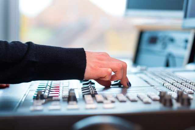 radio presenter in radio station on air