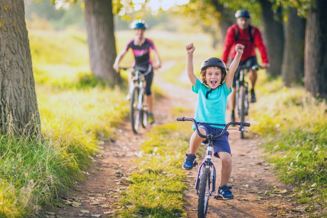 Happy family cycling in the countryside