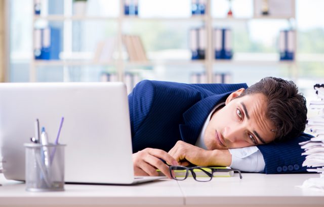Tired businessman exhausted after hard work and excessive worklo