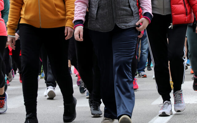 people walk down the street during a demonstration in the city