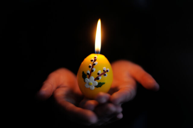 Easter candle in the hands
