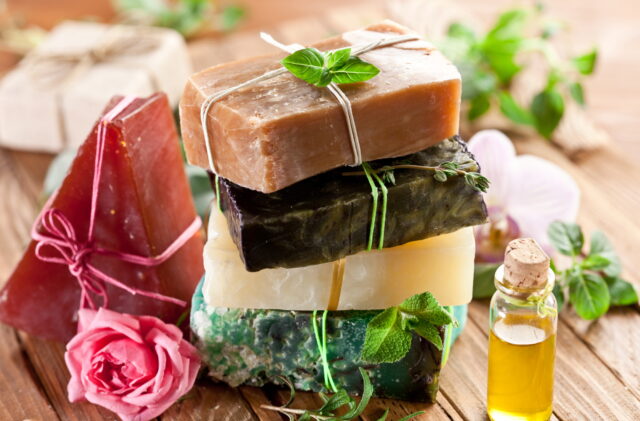 Piece of natural soap with herbs and flowers.