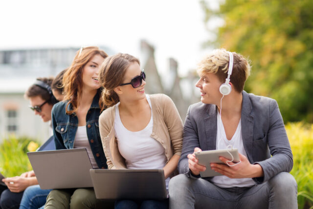 students or teenagers with laptop computers