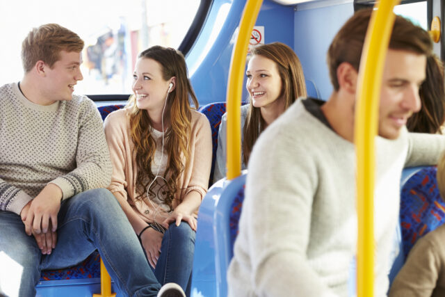 Group Of Young People On Bus Journey Together