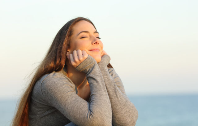 Candid woman breathing fresh air relaxing on the beach