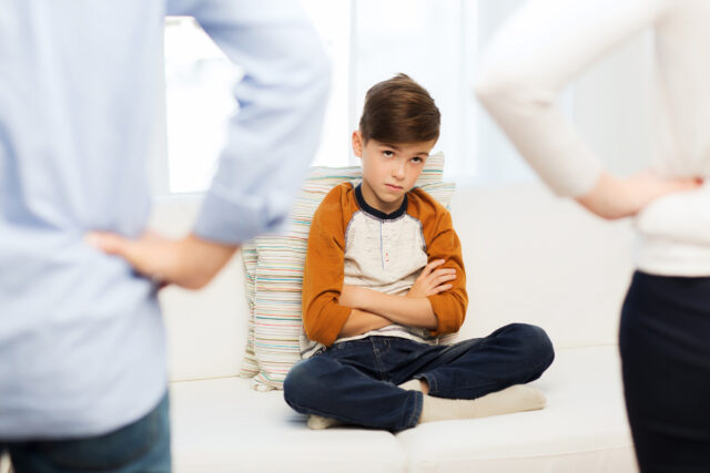 upset or feeling guilty boy and parents at home