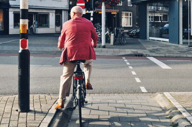 Bicyclist,On,The,Road,Waiting,For,A,Traffic,Light